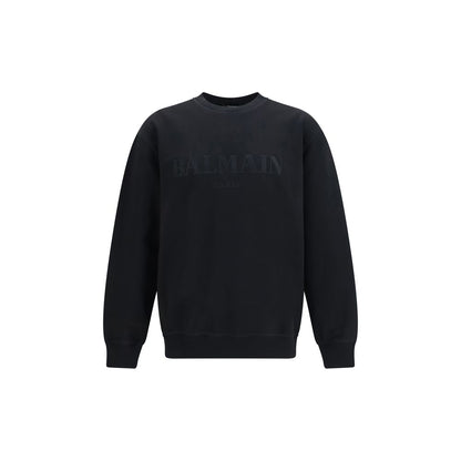 Sweatshirt by Balmain for men in cotton black features an provocated silhouette, detailed with a provocated and a refined crew neckline for a sophisticated aesthetic.