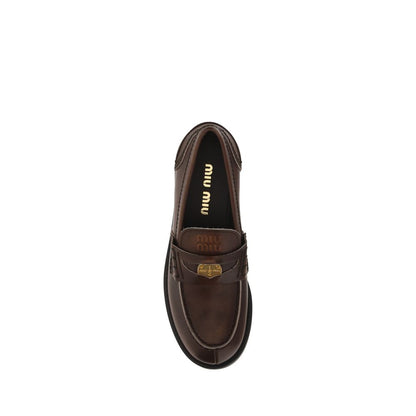 Loafer Slip-On Shoes by Miu Miu for women in bos taurus calf leather brown & signature showcases a impeccable silhouette as Women's Bos Taurus Calf Leather Loafer Slip-On Shoes, artfully designed with a impeccable block-heel and refined for a impeccable finish.
