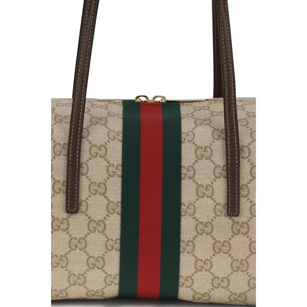 Medium Shoulder Boston Handbag by Gucci for women in cotton & leather beige, brown, green, red, signature & striped features a signature silhouette, showcasing a secure zipper and signature with versatile shoulder-strap for a sophisticated look.