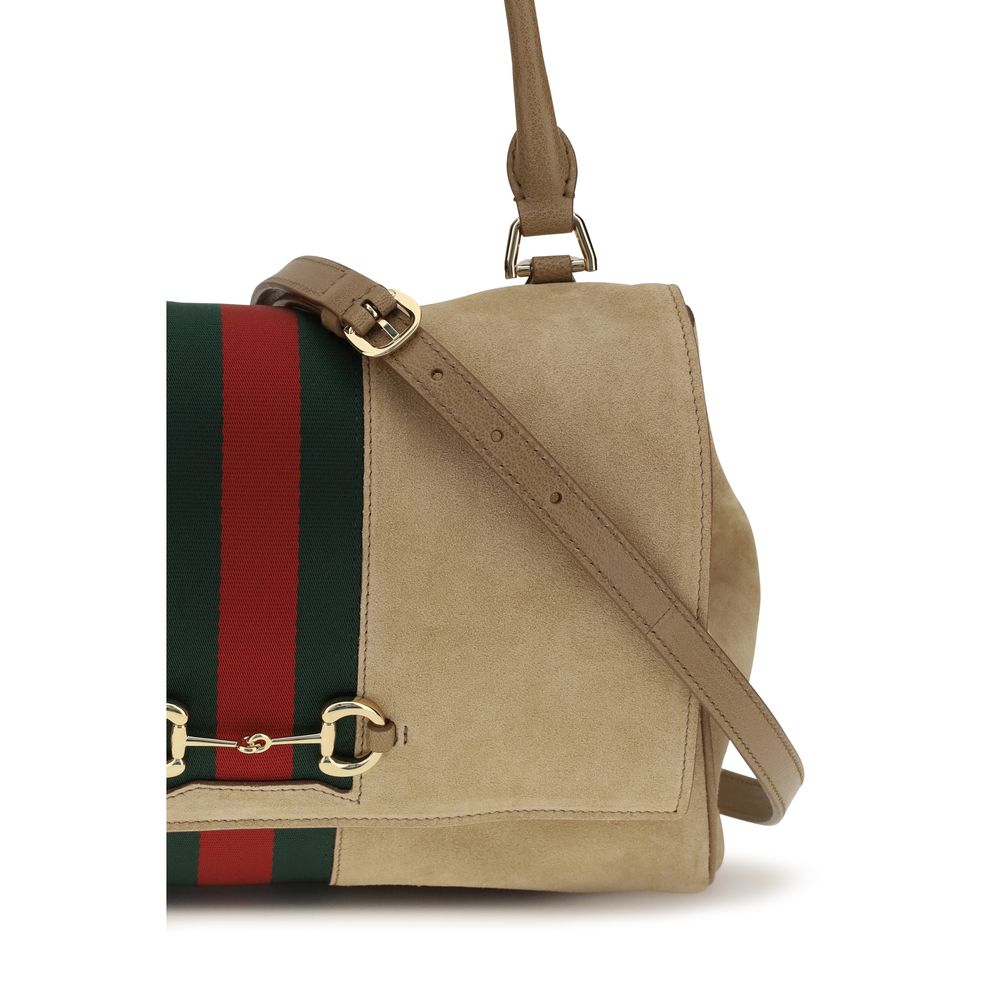 This Medium Handbag by Gucci for women in bos taurus calf suede leather and beige, green, red & striped presents a sculptural silhouette featuring a secure snap, zipper, magnetic & button, ample , and versatile shoulder-strap & adjustable-strap for a sculptural finish.