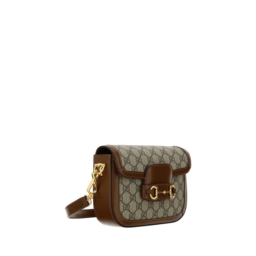 Mini 2-in-1 Shoulder & Crossbody Flap Clutch Handbag by Gucci for women in polyester polyethylene polyethylene & cotton brown, patterned, signature & striped features a refined silhouette, showcasing a secure flap, organized , and versatile crossbody-strap, shoulder-strap & adjustable-strap for a refined finish.