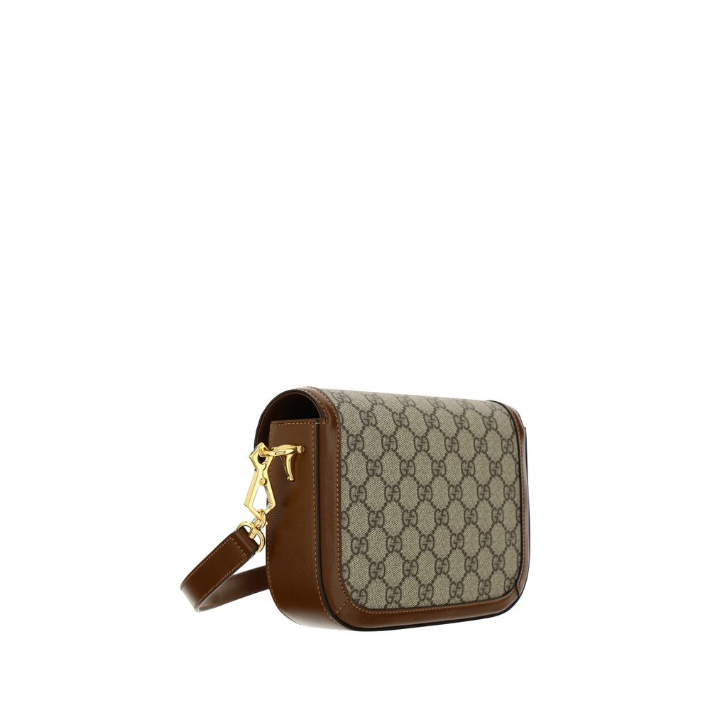 Mini 2-in-1 Shoulder & Crossbody Flap Clutch Handbag by Gucci for women in polyester polyethylene polyethylene & cotton brown, patterned, signature & striped features an refined silhouette, showcasing a secure flap, ample , and versatile crossbody-strap, shoulder-strap & adjustable-strap for a sophisticated refined aesthetic.