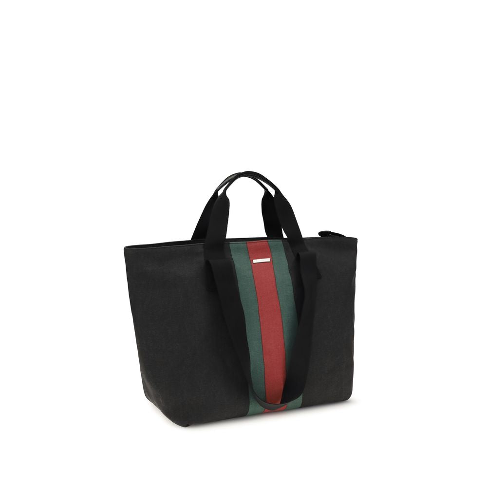 Tote Shoulder Bag by Gucci for men in cotton black & striped showcases a enviable silhouette, artfully detailed with a secure snap & button, organized , and versatile handle for a enviable look.
