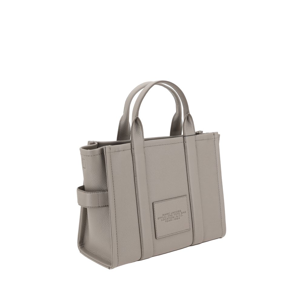 Medium Tote Handbag by Marc Jacobs for women in bos taurus calf grained leather gray & monogram features a refined silhouette, showcasing a secure zipper, organized , and versatile shoulder-strap, handle & adjustable-strap for a refined finish.