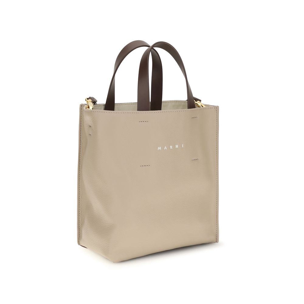 Mini 2-in-1 Shoulder & Crossbody Bag by Marni for women in bos taurus calf leather beige features a distinguished silhouette, showcasing a secure zipper and distinguished with versatile crossbody-strap, shoulder-strap, adjustable-strap & handle for a distinguished finish.