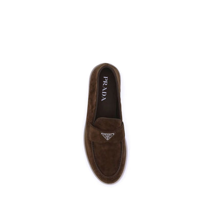 Flat Loafer Slip-On Shoes by Prada for men in bos taurus calf suede leather brown showcases a impeccable silhouette as Men's Bos Taurus Calf Suede Leather Flat Loafer Slip-On Shoes, artfully designed with a impeccable flat and refined almond toe style for a impeccable finish.