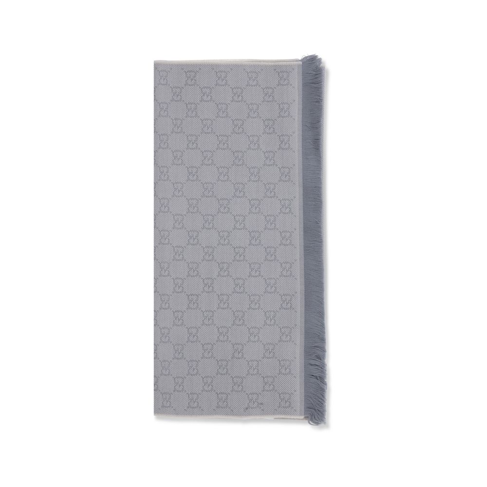 Scarf by Gucci for women in wool gray showcases a warm silhouette from the Gg Grace Wool Wrap Frayed-Edge Scarf collection, offering a warm drape that exudes sophisticated luxury.