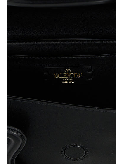 Shoulder Flap Bag by Valentino Garavani for women in leather & metal black & signature presents a statuesque silhouette, showcasing a secure flap & magnetic and statuesque with versatile shoulder-strap, adjustable-strap & handle for a sophisticated look.