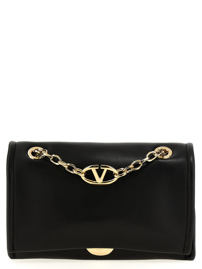 Shoulder Flap Bag by Valentino Garavani for women in lamb leather black showcases a statuesque silhouette, artfully detailed with a secure flap & magnetic, organized , and versatile shoulder-strap & handle for a statuesque look.