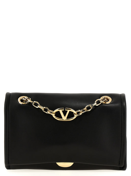 Shoulder Flap Bag by Valentino Garavani for women in lamb leather black showcases a statuesque silhouette, artfully detailed with a secure flap & magnetic, organized , and versatile shoulder-strap & handle for a statuesque look.