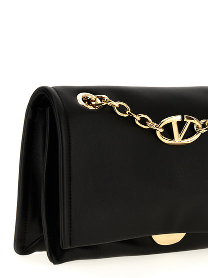 Shoulder Flap Bag by Valentino Garavani for women in lamb leather black showcases a statuesque silhouette, artfully detailed with a secure flap & magnetic, organized , and versatile shoulder-strap & handle for a statuesque look.
