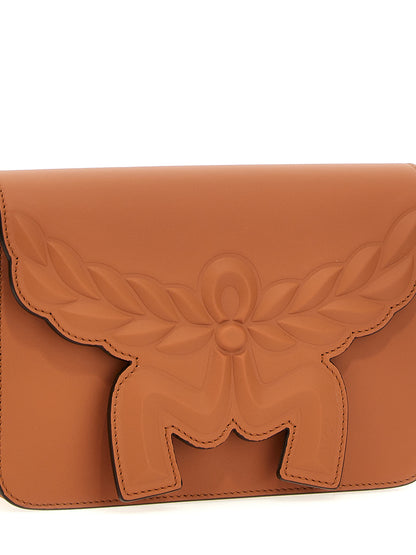 Crossbody Flap Handbag by MCM for women in calfskin leather brown features a transformative sophistication silhouette, showcasing a secure flap & magnetic, ample , and versatile crossbody-strap, shoulder-strap & adjustable-strap for a transformative sophistication look.