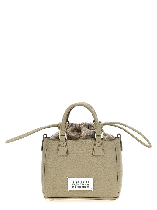 Drawstring Tote Handbag by Maison Margiela for women in calfskin leather gray presents a ornamental silhouette, showcasing a secure drawstring, ample , and versatile shoulder-strap & handle for a ornamental finish.