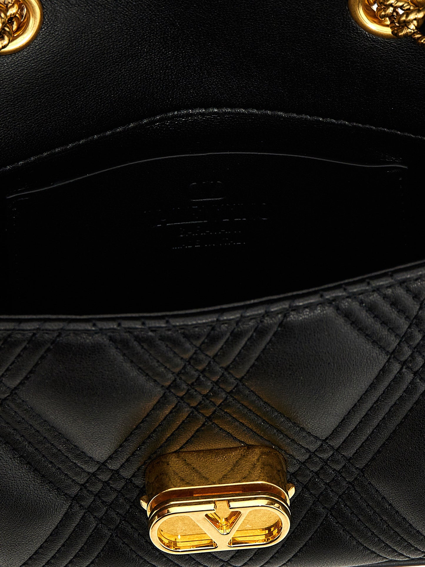 Quilted Shoulder Bag by Valentino Garavani for women in lamb leather black & signature features a statuesque silhouette, showcasing a secure and statuesque with versatile shoulder-strap for a statuesque finish.