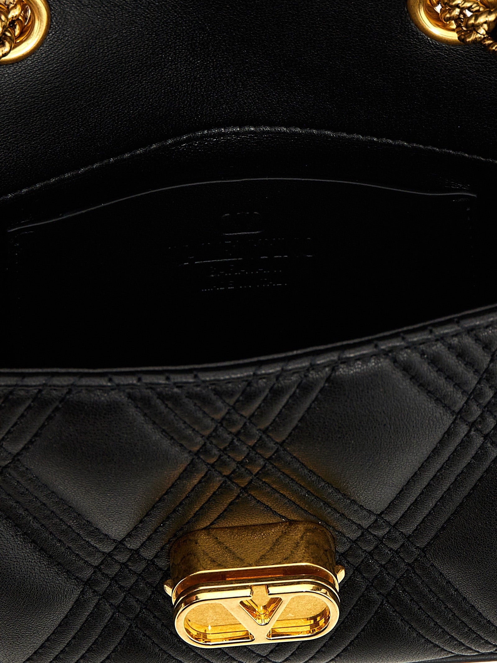 Quilted Shoulder Bag by Valentino Garavani for women in lamb leather black & signature features a statuesque silhouette, showcasing a secure and statuesque with versatile shoulder-strap for a statuesque finish.