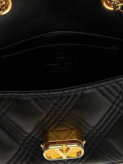 Quilted Shoulder Bag by Valentino Garavani for women in lamb leather black & signature features a statuesque silhouette, showcasing a secure and statuesque with versatile shoulder-strap for a statuesque finish.