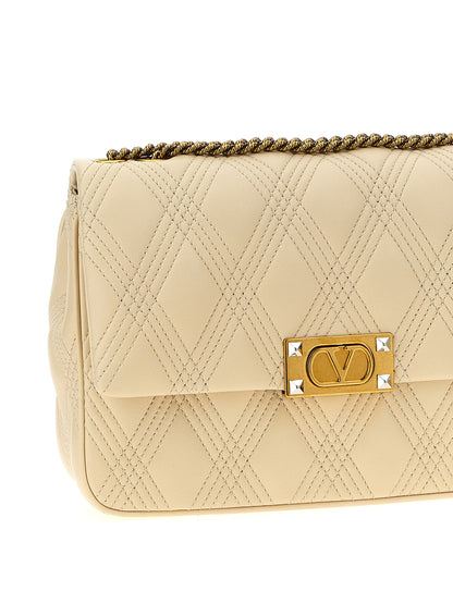 Quilted Shoulder Flap Bag by Valentino Garavani for women in lamb leather white & signature features a effortless chic silhouette with a secure flap, ample , and versatile shoulder-strap for a effortless chic finish.
