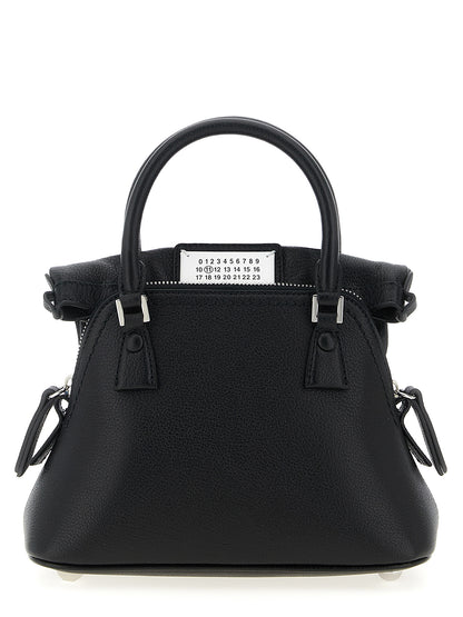 Micro Handbag by Maison Margiela for women in calfskin leather black & signature features a ornamental silhouette, showcasing a secure zipper, ample , and ornamental shoulder-strap & handle for a sophisticated look.