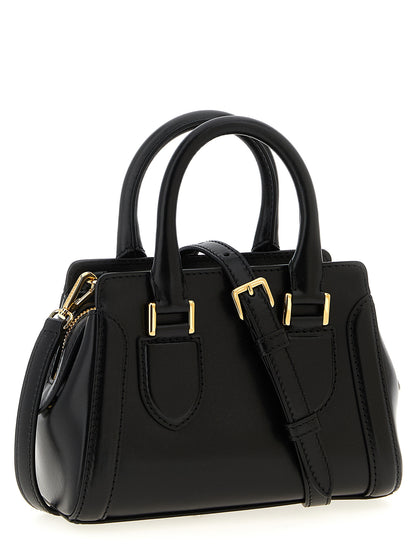 Mini Crossbody Handbag by Alexander McQueen for women in calfskin leather black features a ornamental silhouette, showcasing a secure zipper, ample , and ornamental crossbody-strap, shoulder-strap, adjustable-strap & handle for a sophisticated look.