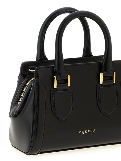 This Mini Crossbody Handbag by Alexander McQueen for women in calfskin leather and black presents a sculptural silhouette featuring a secure zipper, ample , and versatile crossbody-strap, shoulder-strap, adjustable-strap & handle for a sculptural finish.