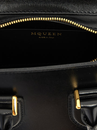 Mini Crossbody Handbag by Alexander McQueen for women in calfskin leather black presents a ornamental silhouette, showcasing a secure zipper, ample , and versatile crossbody-strap, shoulder-strap, adjustable-strap & handle for a ornamental finish.