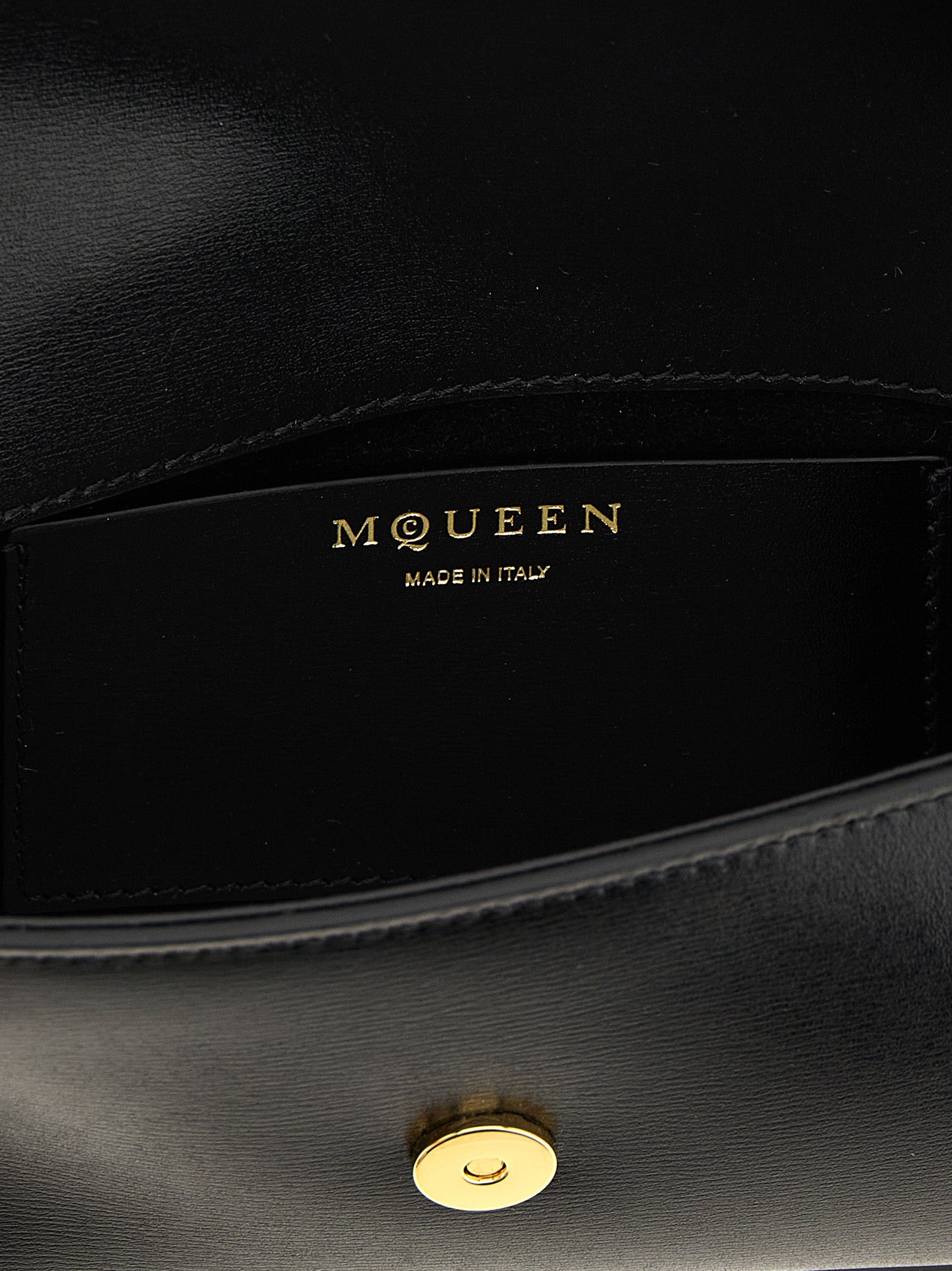 Small Crossbody East West Flap Handbag by Alexander McQueen for women in calfskin leather black & signature features a transformative sophistication silhouette, showcasing a secure flap & magnetic, ample , and versatile crossbody-strap & shoulder-strap for a transformative sophistication look.