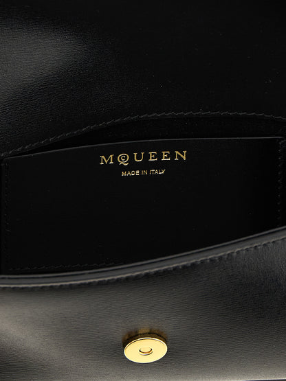 Small Crossbody East West Flap Handbag by Alexander McQueen for women in calfskin leather black & signature features a transformative sophistication silhouette, showcasing a secure flap & magnetic, ample , and versatile crossbody-strap & shoulder-strap for a transformative sophistication look.