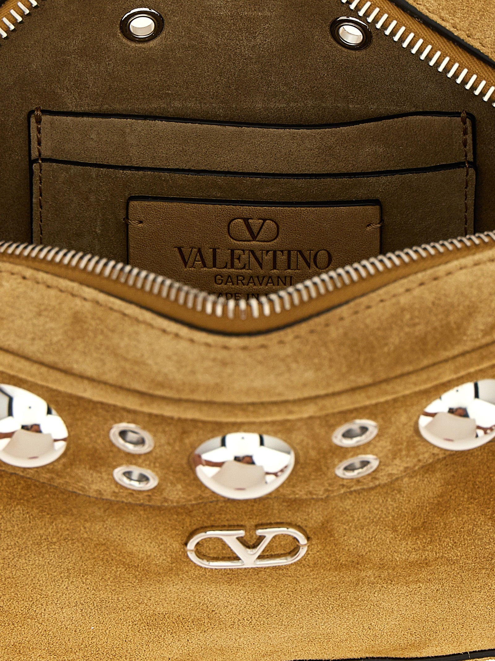 Crossbody Messenger Handbag by Valentino Garavani for unisex in suede leather beige & signature features a transformative sophistication silhouette, showcasing a secure zipper, ample , and versatile crossbody-strap, shoulder-strap & adjustable-strap for a transformative sophistication look.