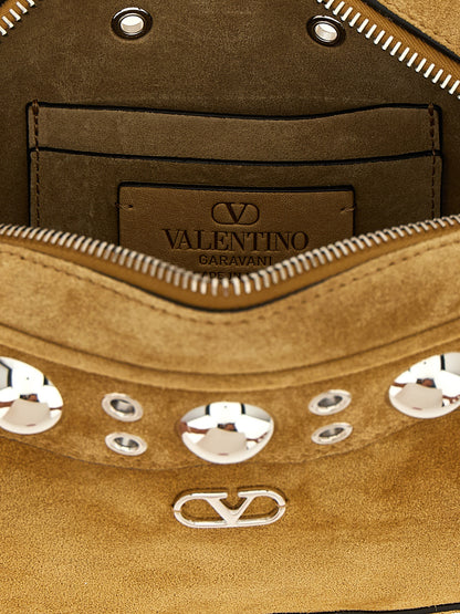 Crossbody Messenger Handbag by Valentino Garavani for unisex in suede leather beige & signature features a transformative sophistication silhouette, showcasing a secure zipper, ample , and versatile crossbody-strap, shoulder-strap & adjustable-strap for a transformative sophistication look.