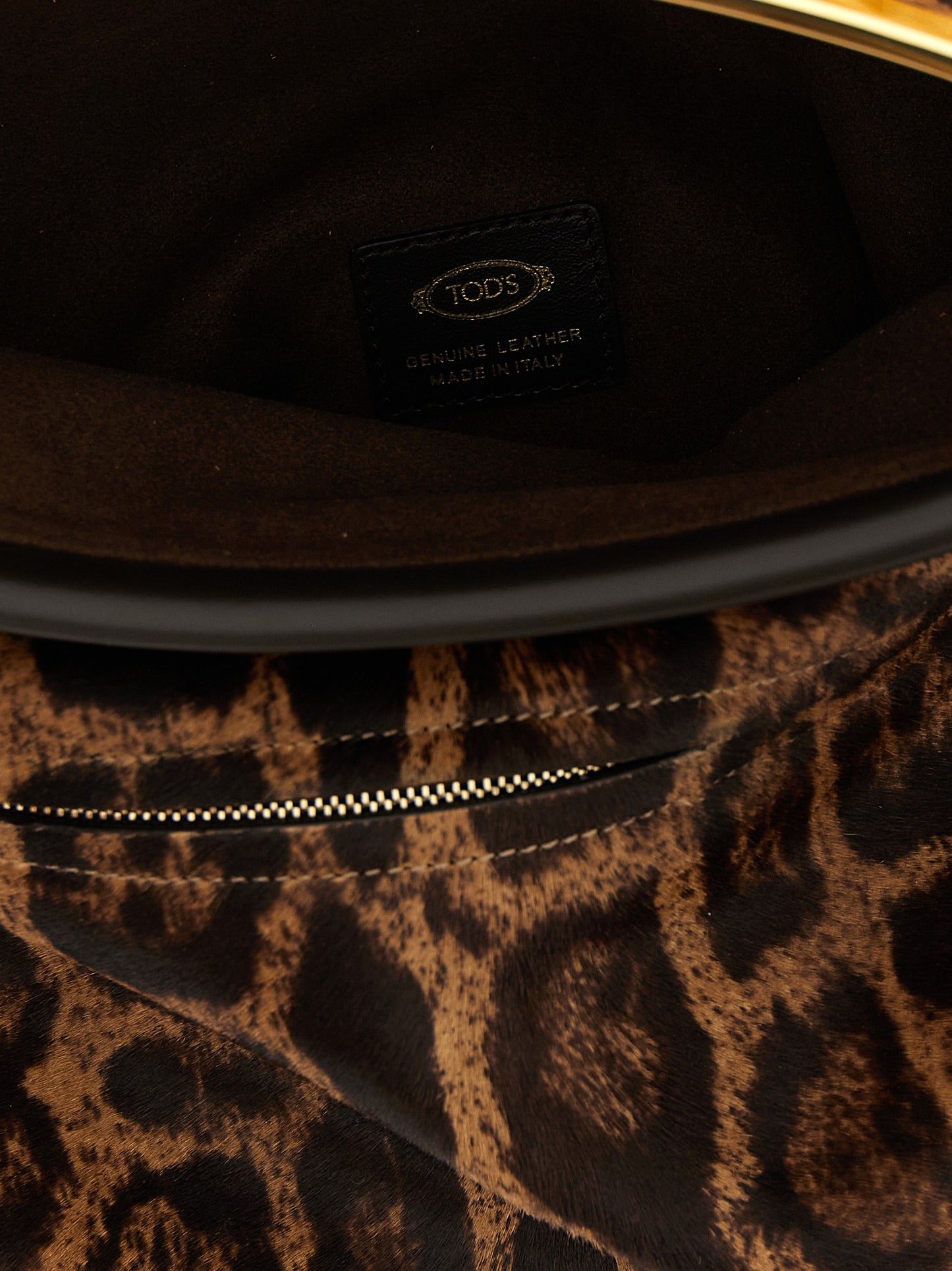 Shoulder Flap Bag by Tod's for women in calfskin leather animal, brown, magenta & print showcases a statuesque silhouette, artfully detailed with a secure snap, flap & zipper, organized , and versatile shoulder-strap, adjustable-strap & handle for a statuesque look.