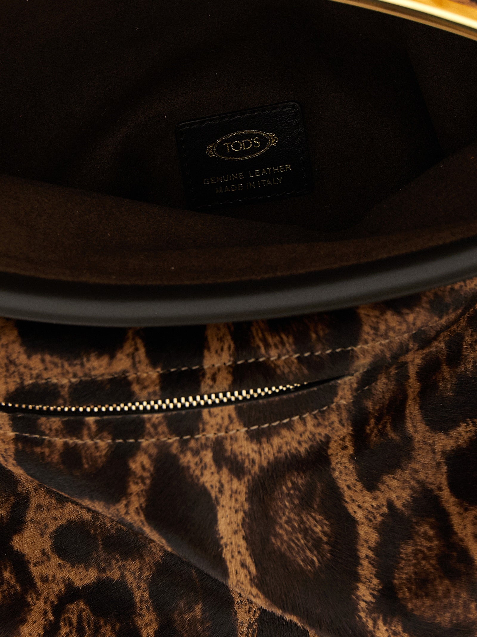 Shoulder Flap Bag by Tod's for women in calfskin leather animal, brown, magenta & print showcases a statuesque silhouette, artfully detailed with a secure snap, flap & zipper, organized , and versatile shoulder-strap, adjustable-strap & handle for a statuesque look.
