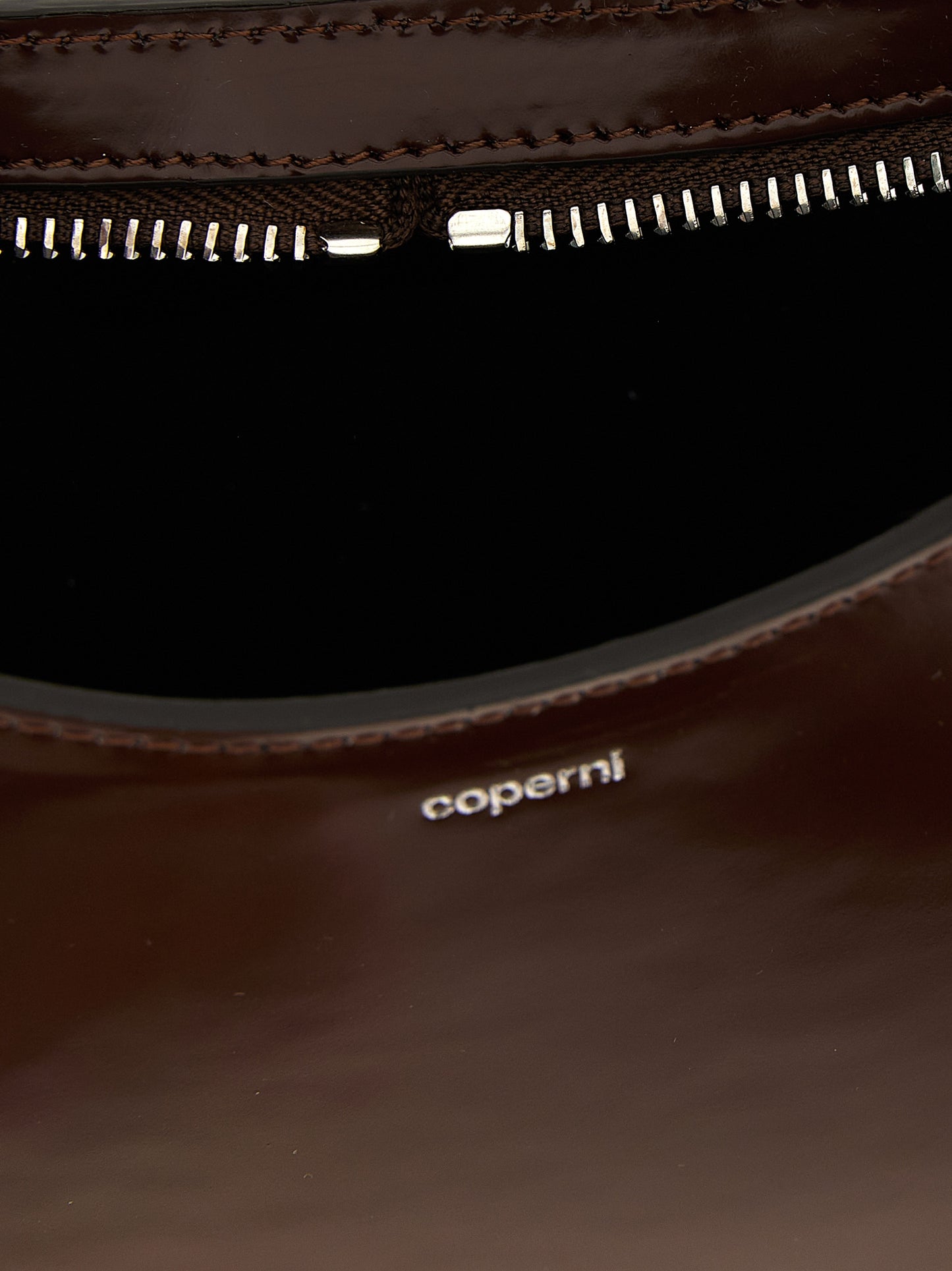 Handbag by Coperni for women in leather brown features an refined silhouette, showcasing a secure zipper, ample , and versatile handle for a sophisticated refined aesthetic.