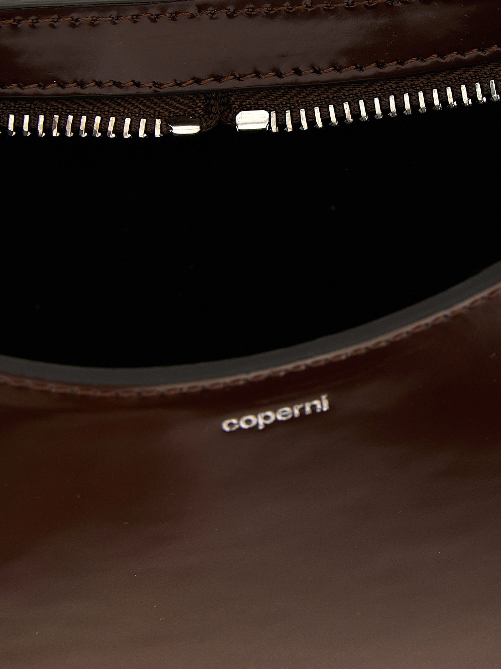 Handbag by Coperni for women in leather brown features an refined silhouette, showcasing a secure zipper, ample , and versatile handle for a sophisticated refined aesthetic.