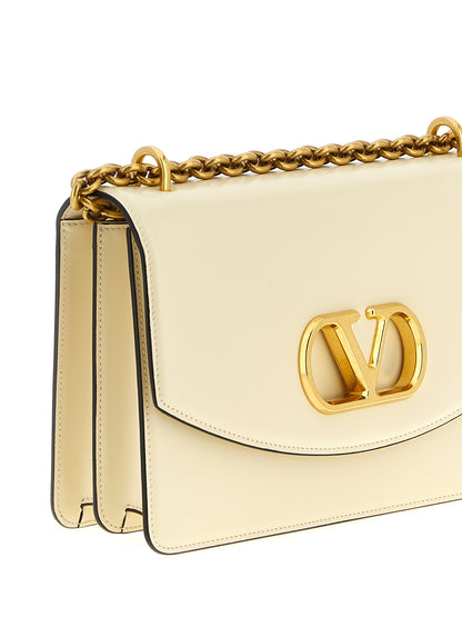 Shoulder Flap Bag by Valentino Garavani for women in calfskin leather white & signature showcases a statuesque silhouette, artfully detailed with a secure flap & magnetic, organized , and versatile shoulder-strap for a statuesque look.
