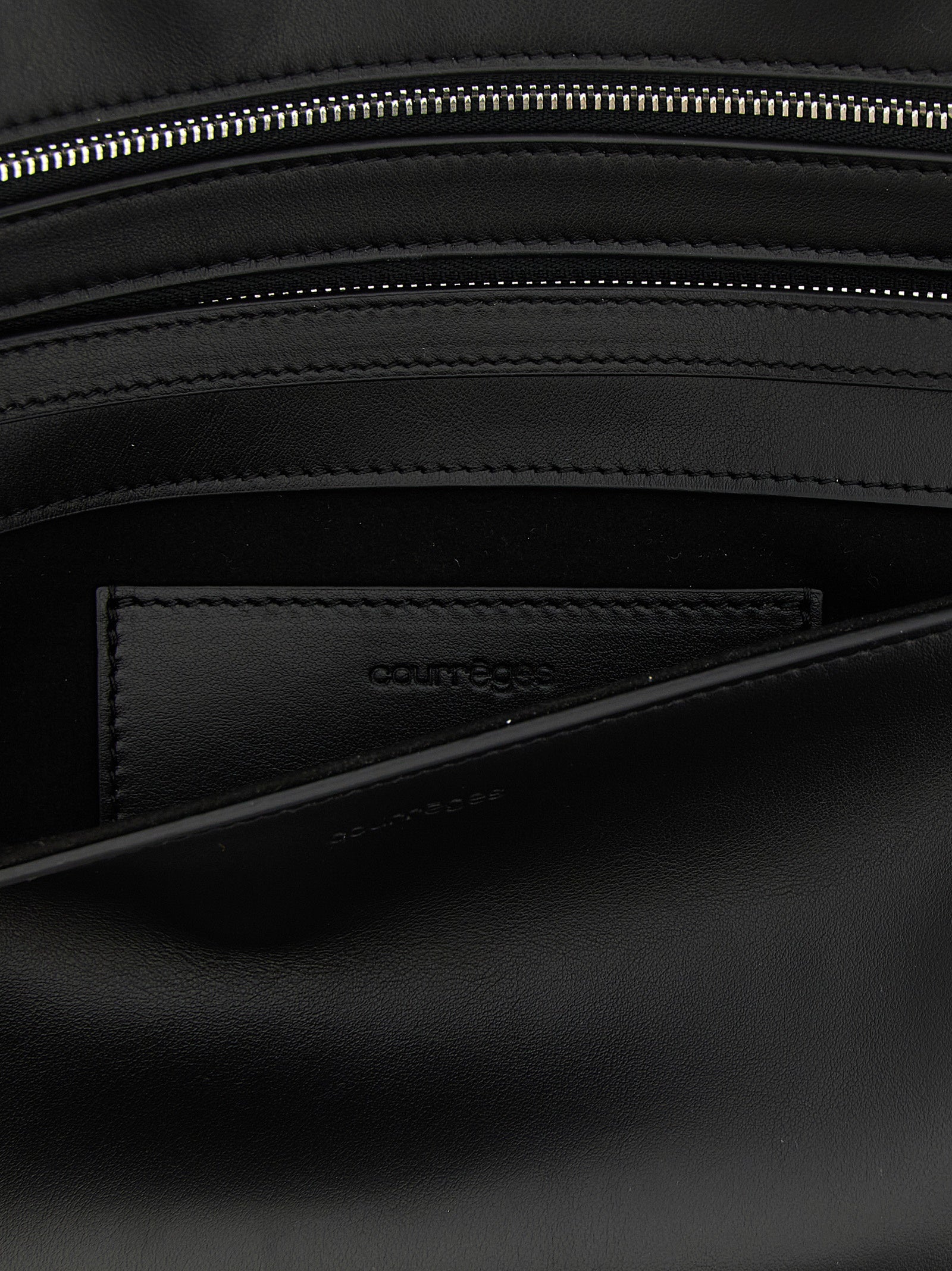 Shoulder Flap Clutch Handbag by Courrèges for women in denim cotton & acetate black features a sculptural silhouette with a secure flap, zipper & magnetic, organized , and versatile shoulder-strap, wristlet, adjustable-strap & handle for a sculptural finish.