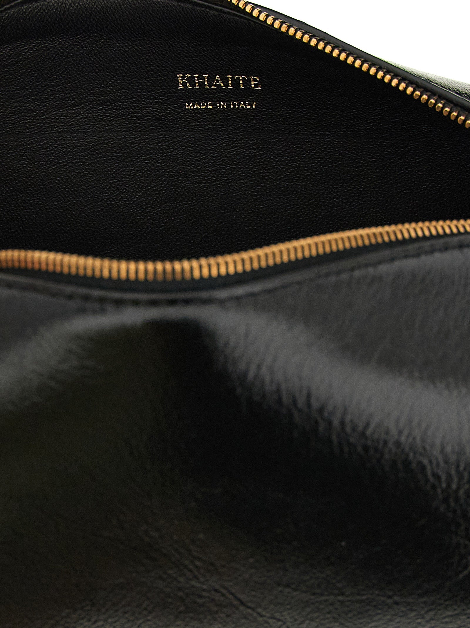 Mini East West Crossbody Handbag by Khaite for women in calfskin leather black features a multifaceted silhouette, showcasing a secure zipper and multifaceted with versatile crossbody-strap, shoulder-strap & adjustable-strap for multifaceted style.