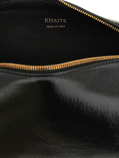 Mini East West Crossbody Handbag by Khaite for women in calfskin leather black features a multifaceted silhouette, showcasing a secure zipper and multifaceted with versatile crossbody-strap, shoulder-strap & adjustable-strap for multifaceted style.
