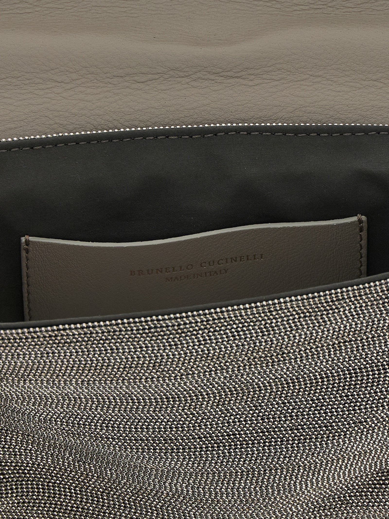 Crossbody Flap Clutch Handbag by Brunello Cucinelli for women in nappa leather & rubber silver features an sculptural silhouette, showcasing a secure flap & magnetic and sculptural with versatile crossbody-strap, shoulder-strap & adjustable-strap for a sophisticated look.
