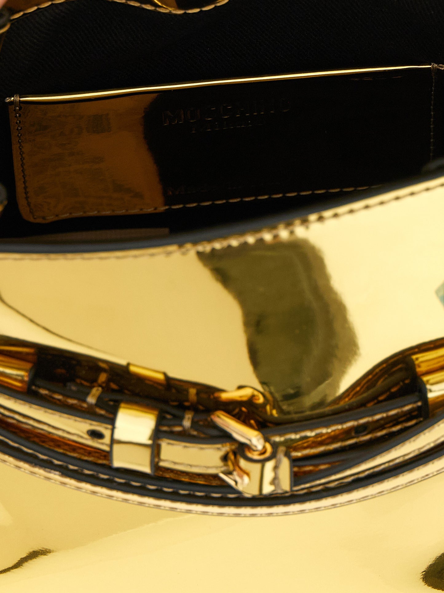 Handbag by Moschino for women in polyester & polyethylene gold features an refined silhouette, showcasing a secure buckle & button, ample , and versatile shoulder-strap, adjustable-strap & handle for a sophisticated refined aesthetic.