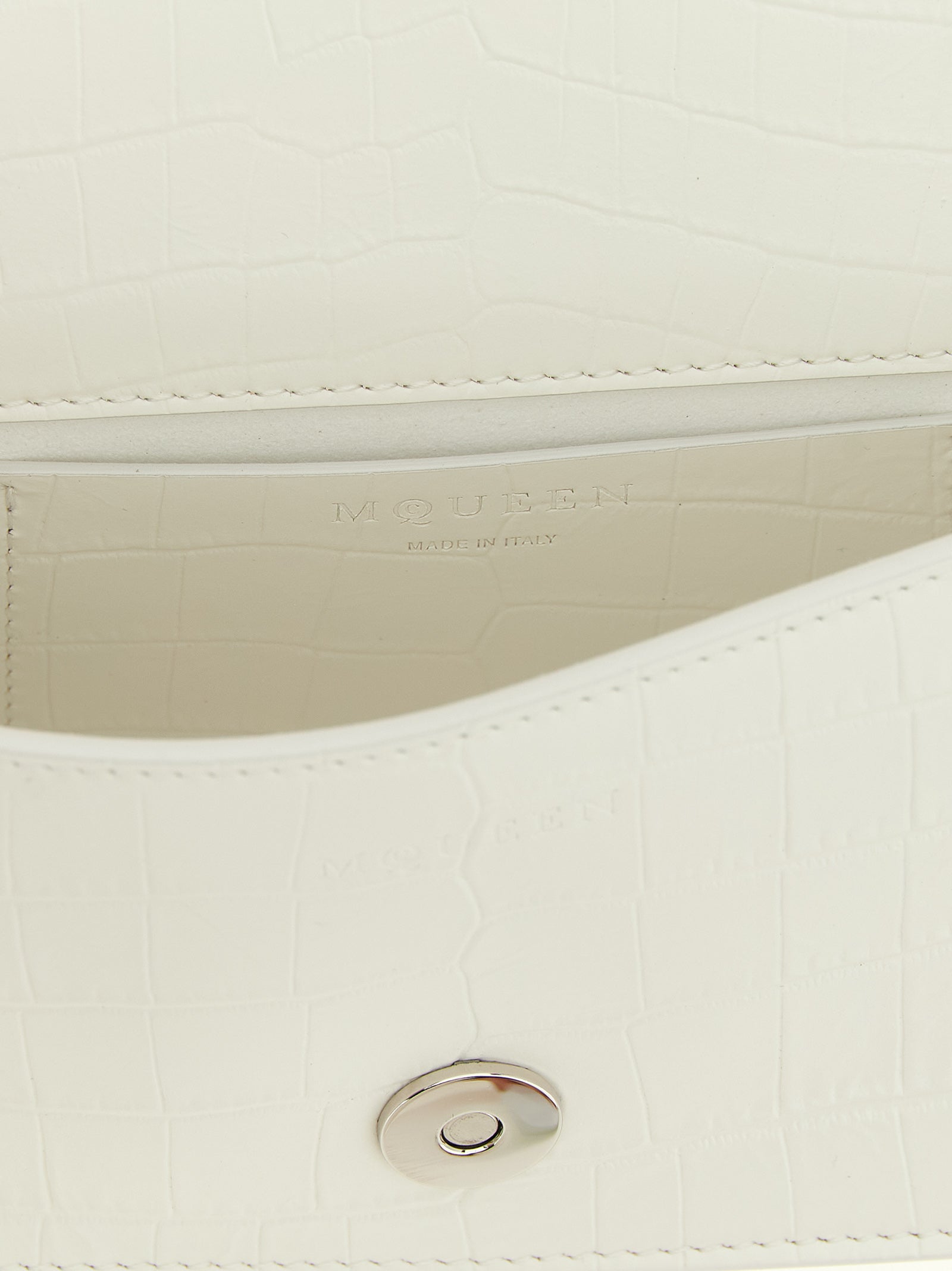 Mini Shoulder Flap Bag by Alexander McQueen for women in calfskin leather white, signature & print features a statuesque silhouette, showcasing a secure flap & magnetic and statuesque with versatile shoulder-strap, adjustable-strap & handle for a statuesque finish.