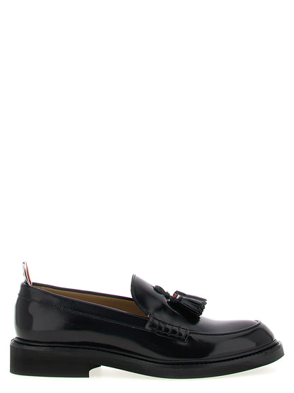Flat Loafer Slip-On Shoes by Thom Browne for women in bos taurus calfskin leather black & signature showcases a impeccable silhouette as Women's Bos Taurus Calfskin Leather Flat Loafer Slip-On Shoes, artfully designed with a impeccable flat and refined for a impeccable finish.