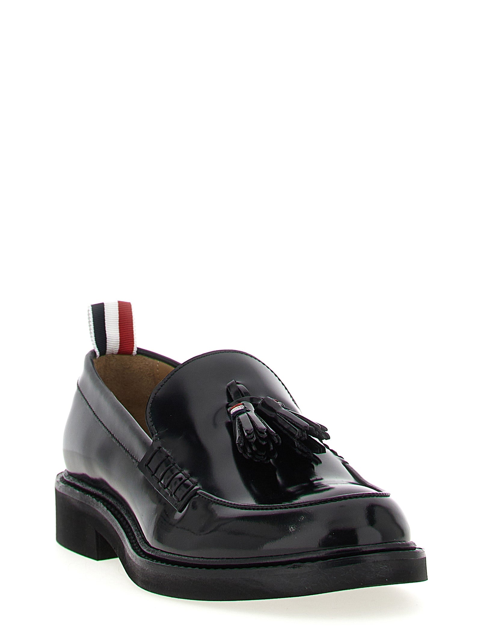 This Flat Loafer Slip-On Shoes by Thom Browne for women in bos taurus calfskin leather black & signature features an exquisite silhouette from the Women's Bos Taurus Calfskin Leather Flat Loafer Slip-On Shoes collection, defined by a sophisticated flat and elegant .