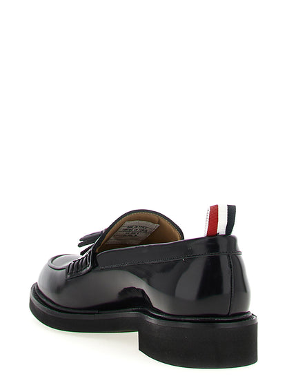 Flat Loafer Slip-On Shoes by Thom Browne for women in bos taurus calfskin leather black & signature features an effortless chic silhouette, showcasing the Women's Bos Taurus Calfskin Leather Flat Loafer Slip-On Shoes design with an effortless chic flat and a for a effortless chic look.