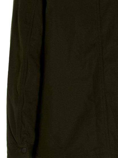 Overcoat by SOUTH2 WEST8 for men in cotton corduroy bicolour & green showcases a architectural silhouette, artfully detailed with a distinctive and functional pockets for a architectural finish.