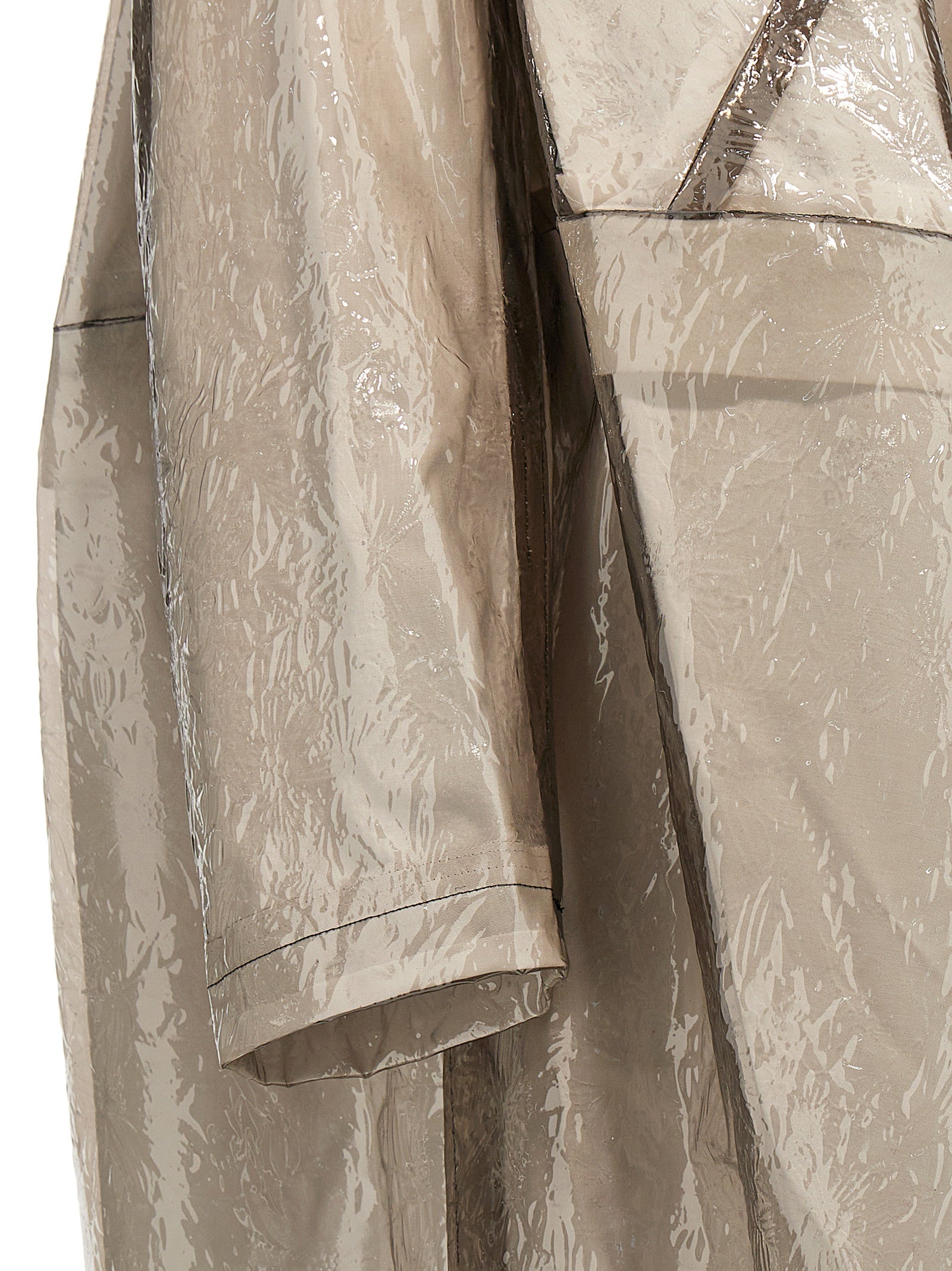 Trench Coat by Comme Des Garçons for women in polyethylene & polyurethane gray features an dramatic silhouette, perfectly showcasing the elegant and sophisticated pockets for a truly dramatic aesthetic.