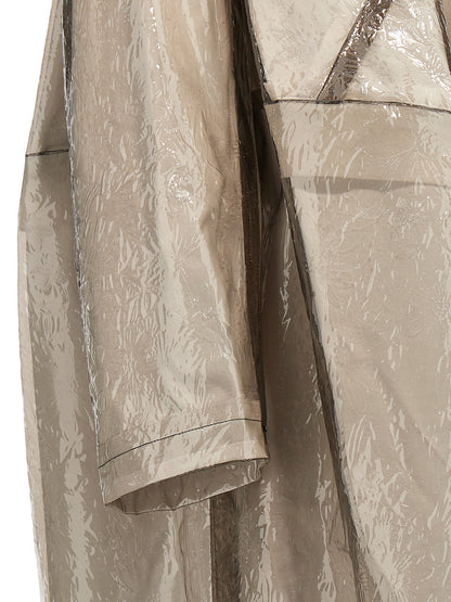 Trench Coat by Comme Des Garçons for women in polyethylene & polyurethane gray features an dramatic silhouette, perfectly showcasing the elegant and sophisticated pockets for a truly dramatic aesthetic.