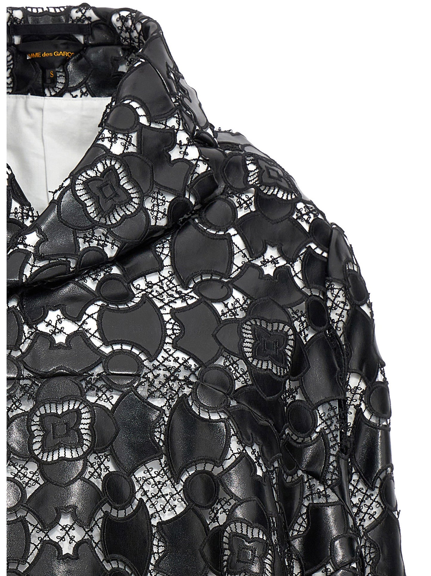 Jacket by Comme Des Garçons for women in polyethylene polyurethane leather bicolour, black, white & patterned showcases a enveloping silhouette, artfully detailed with a enveloping and premium for a truly enveloping finish.