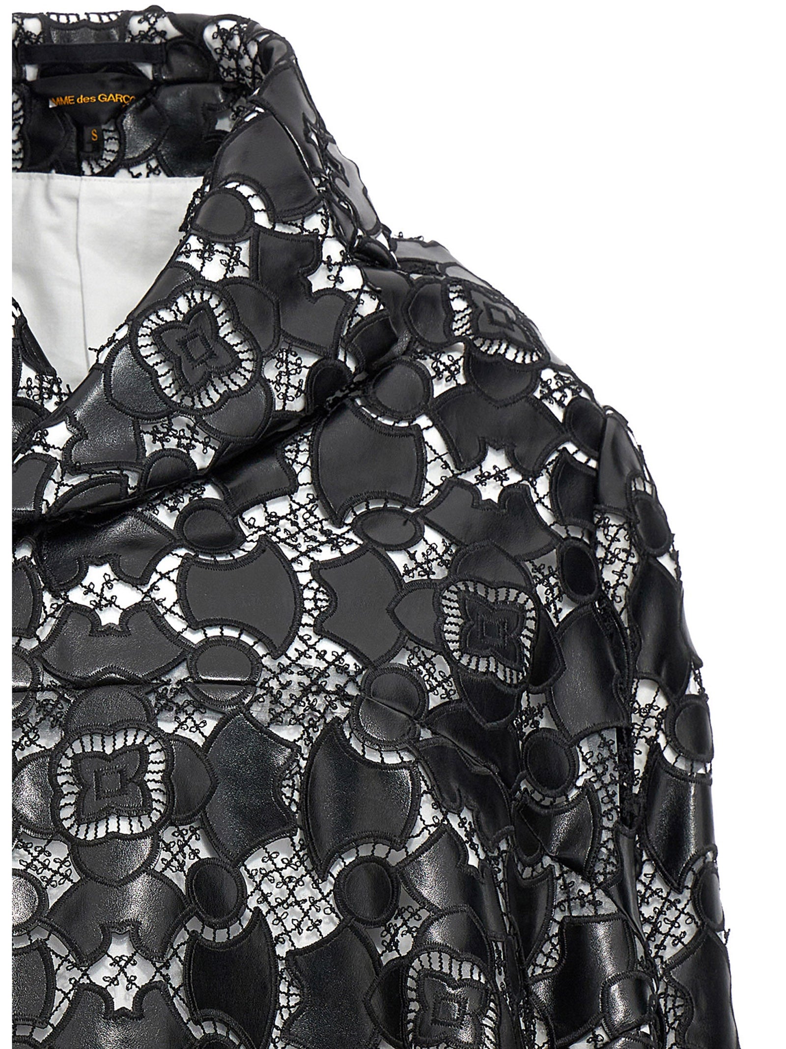 Jacket by Comme Des Garçons for women in polyethylene polyurethane leather bicolour, black, white & patterned showcases a enveloping silhouette, artfully detailed with a enveloping and premium for a truly enveloping finish.