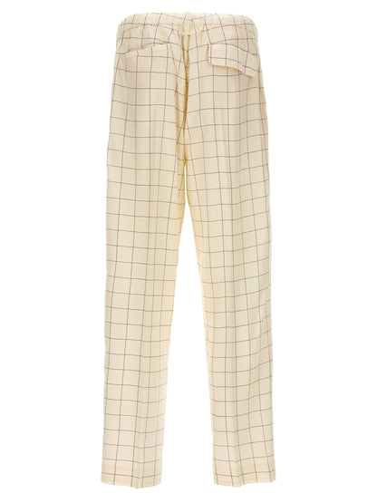 Casual Pants by Undercover for men in rayon silk bicolour, black, white & checkered features a refined silhouette with a refined , defined by a and a refined long for a refined finish.