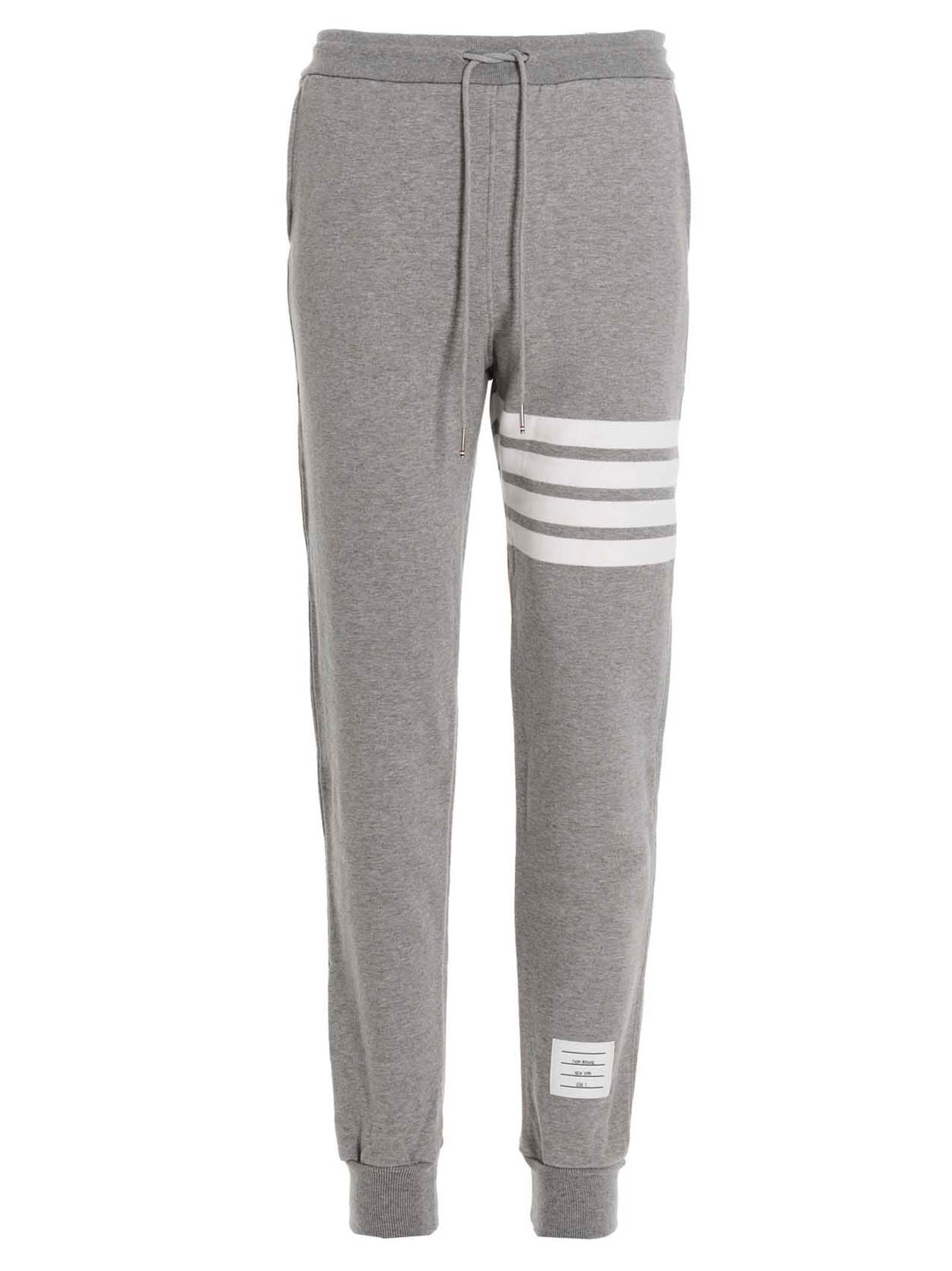 Joggers by Thom Browne for men in cotton gray features a polished silhouette with a polished , reaching a polished long and finished with a polished .